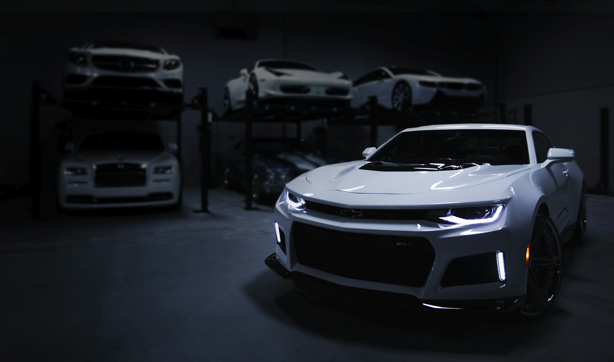 A dark luxury car photographed in soft, architectural light.